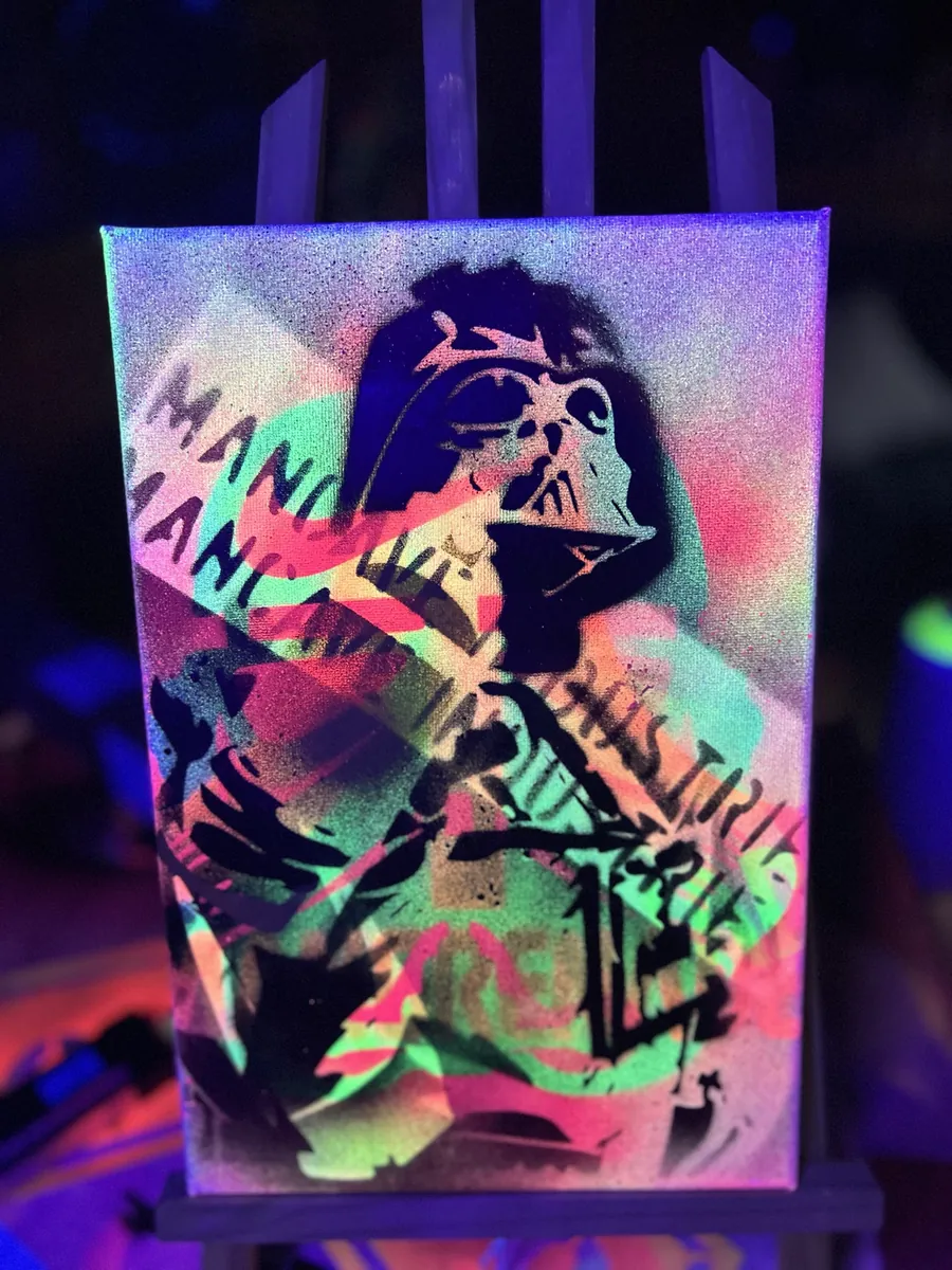 Helmeted figure through neon green and pink layers, under blacklight