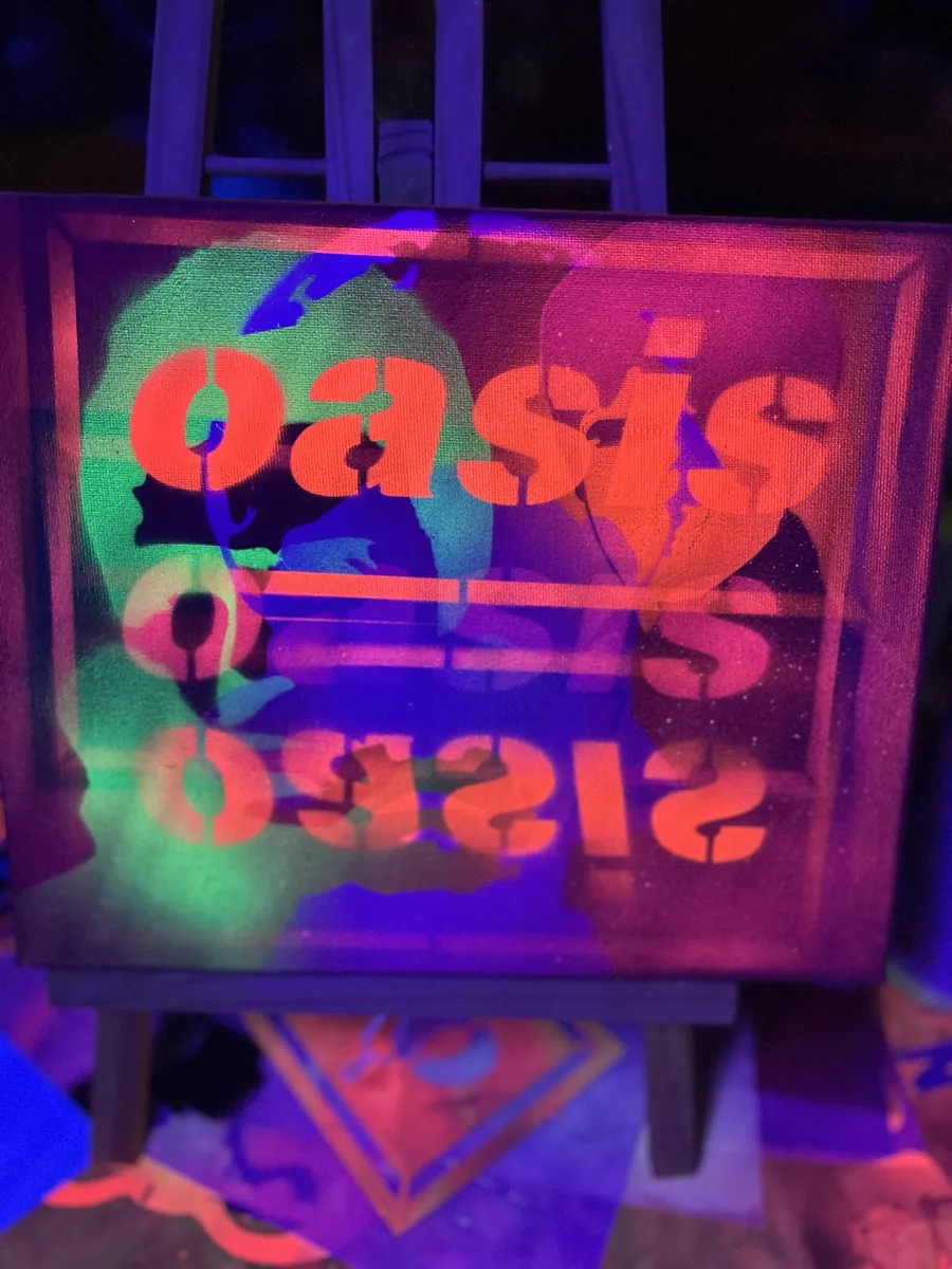 Block lettering stencilled upright and reflected, under blacklight